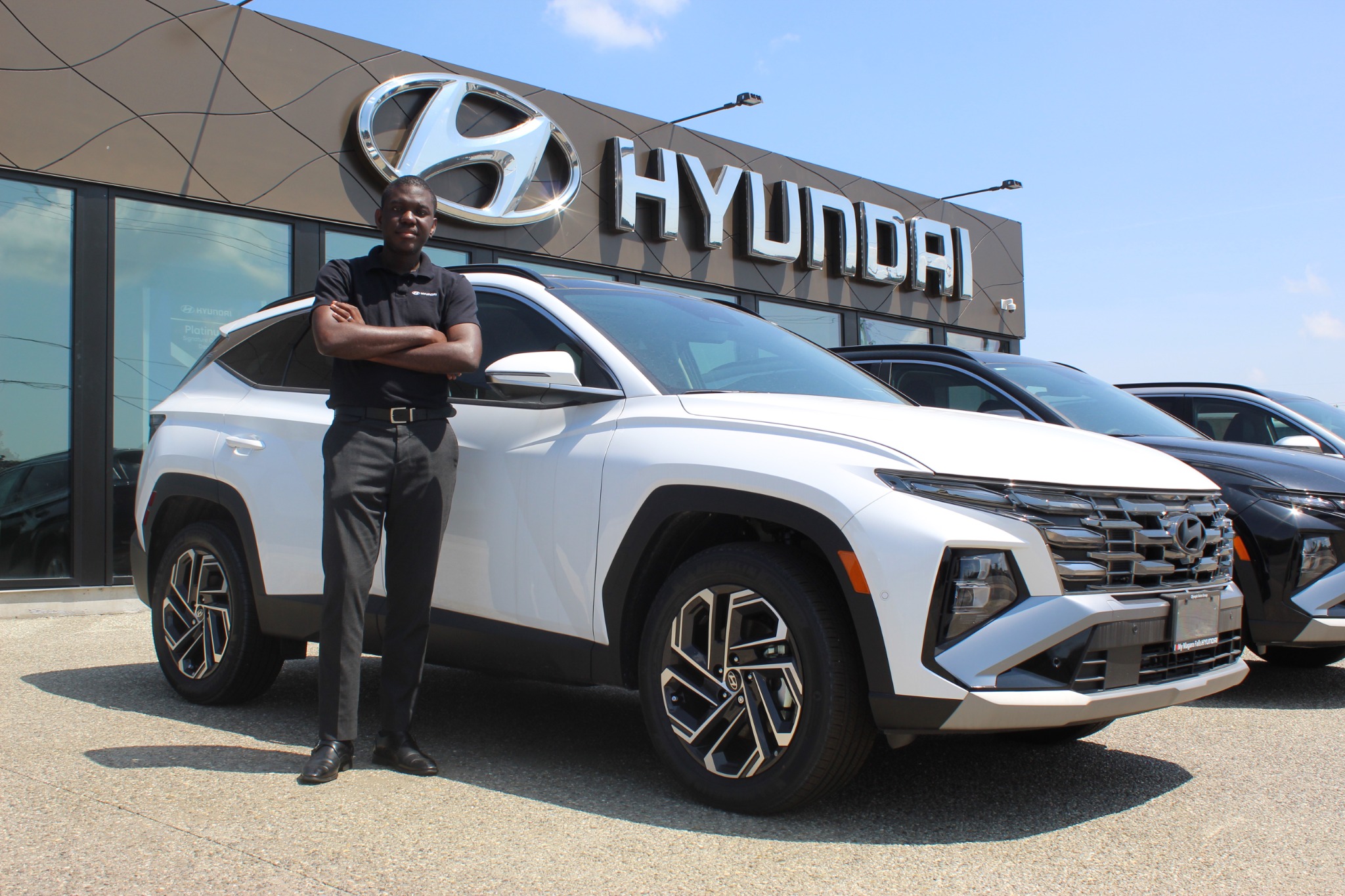 Ife Solomon beside a white Hyundai Tucson at Olympic Hyundai